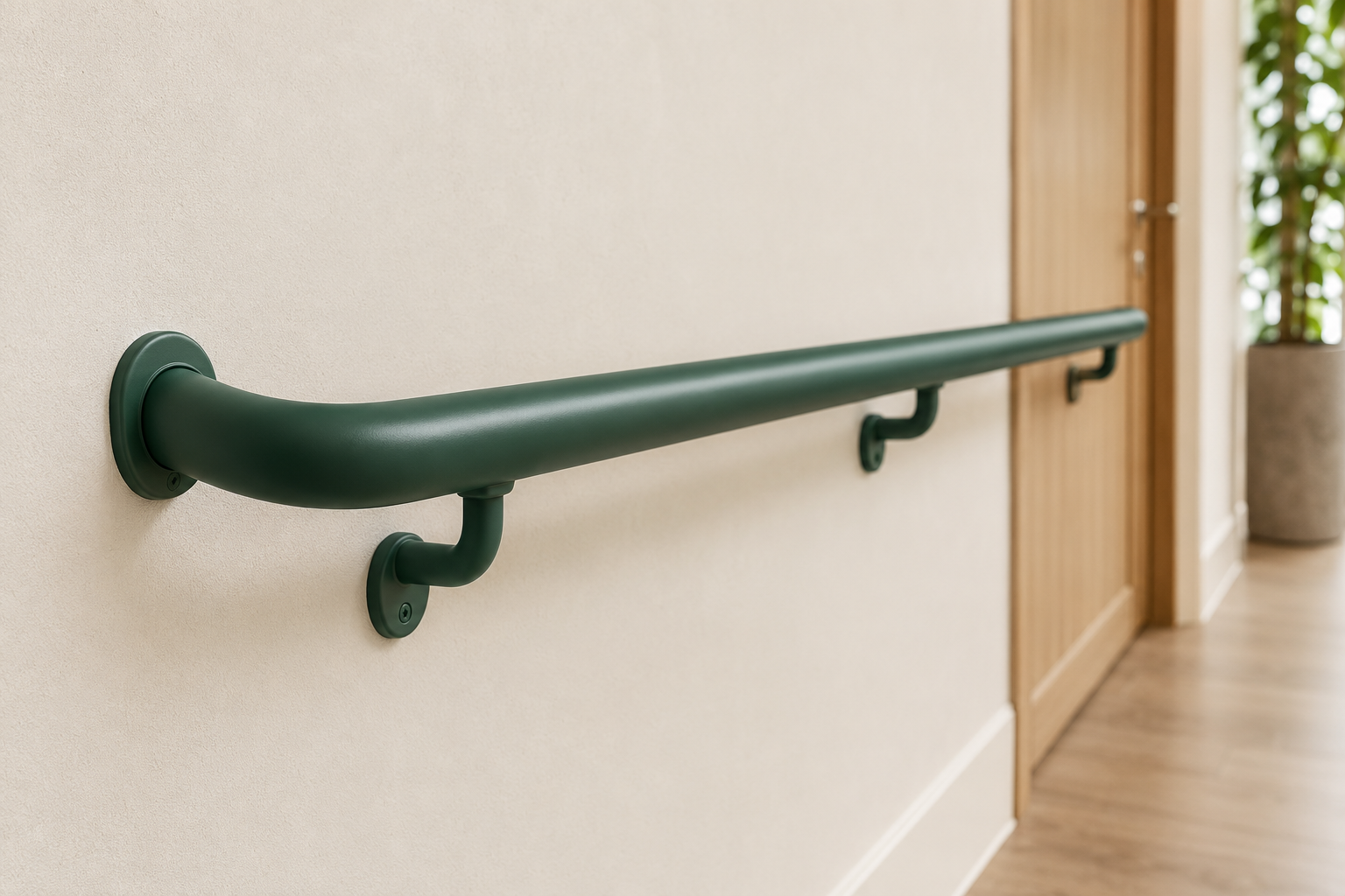 Forest green handrail with wall brackets in an aged-care corridor